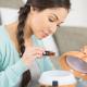 Woman Pouring Lavender Essential Oil in Diffuser