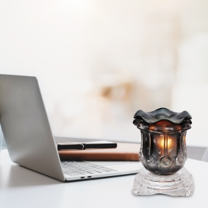 Black Tulip Light Dimming Oil Warmer Next to a Laptop